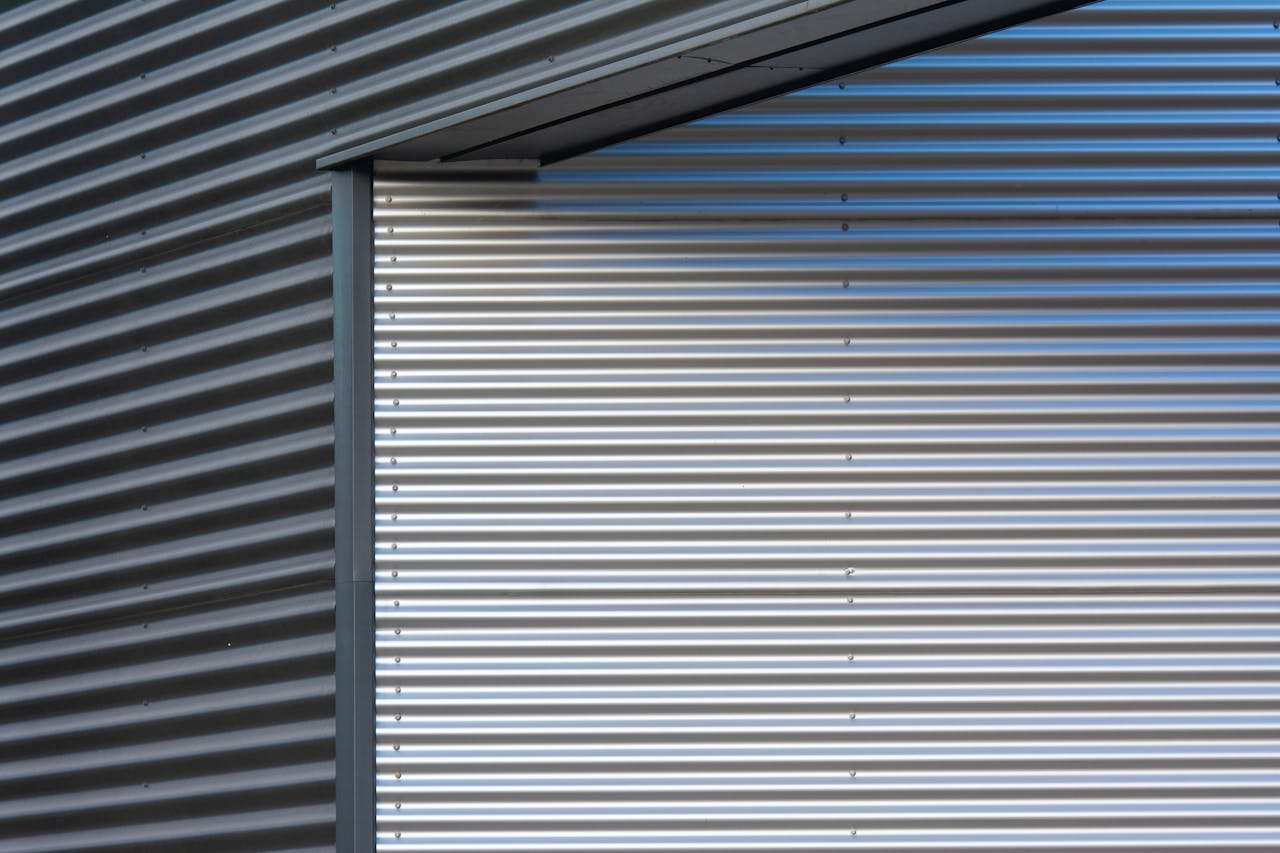 services-03 Detailed shot of a corrugated metal wall, showcasing industrial texture and pattern.