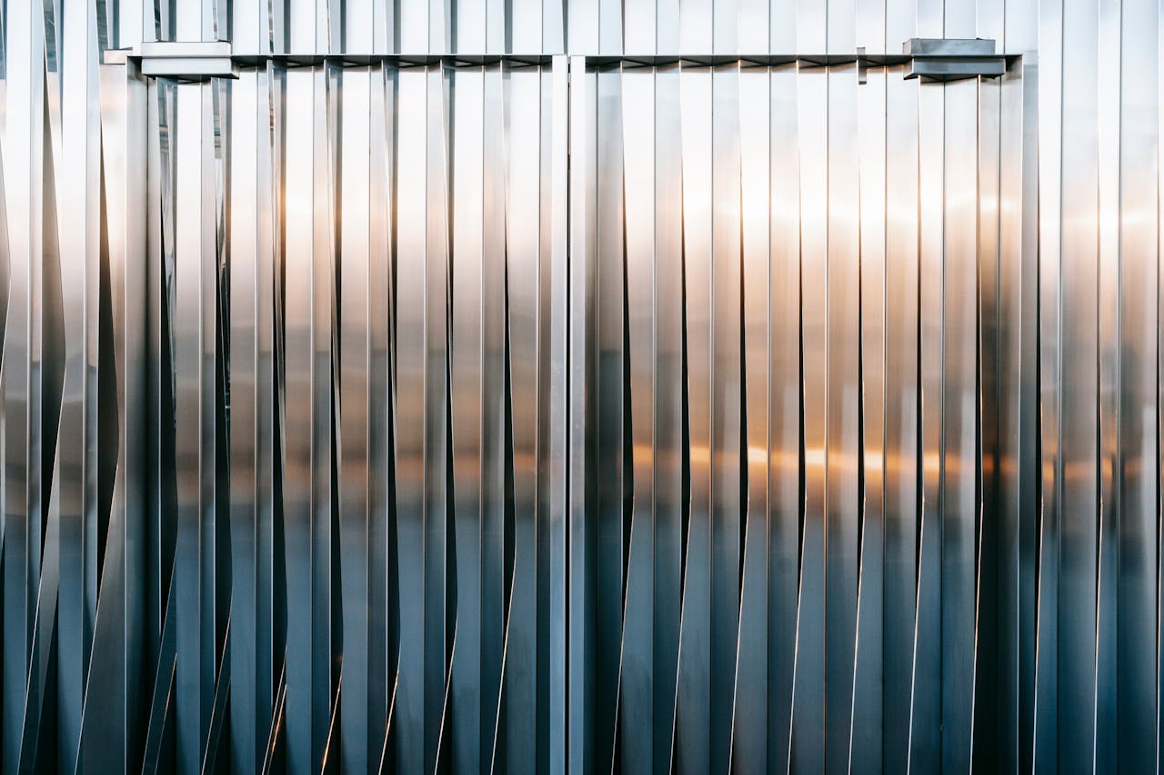 services-01 Symmetrical steel facade featuring geometric patterns and subtle reflections.